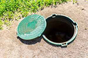 Cover of septic tank removed. Speedy Septic serving OR and WA provides septic tank repair services. 
