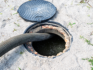 A four-inch suction pipe inserted into a home septic tank, suction of household wastewater for septic tank pumping and septic tank cleaning