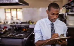 A portland city inspector evaluates fog disposal system in commercial kitchen
